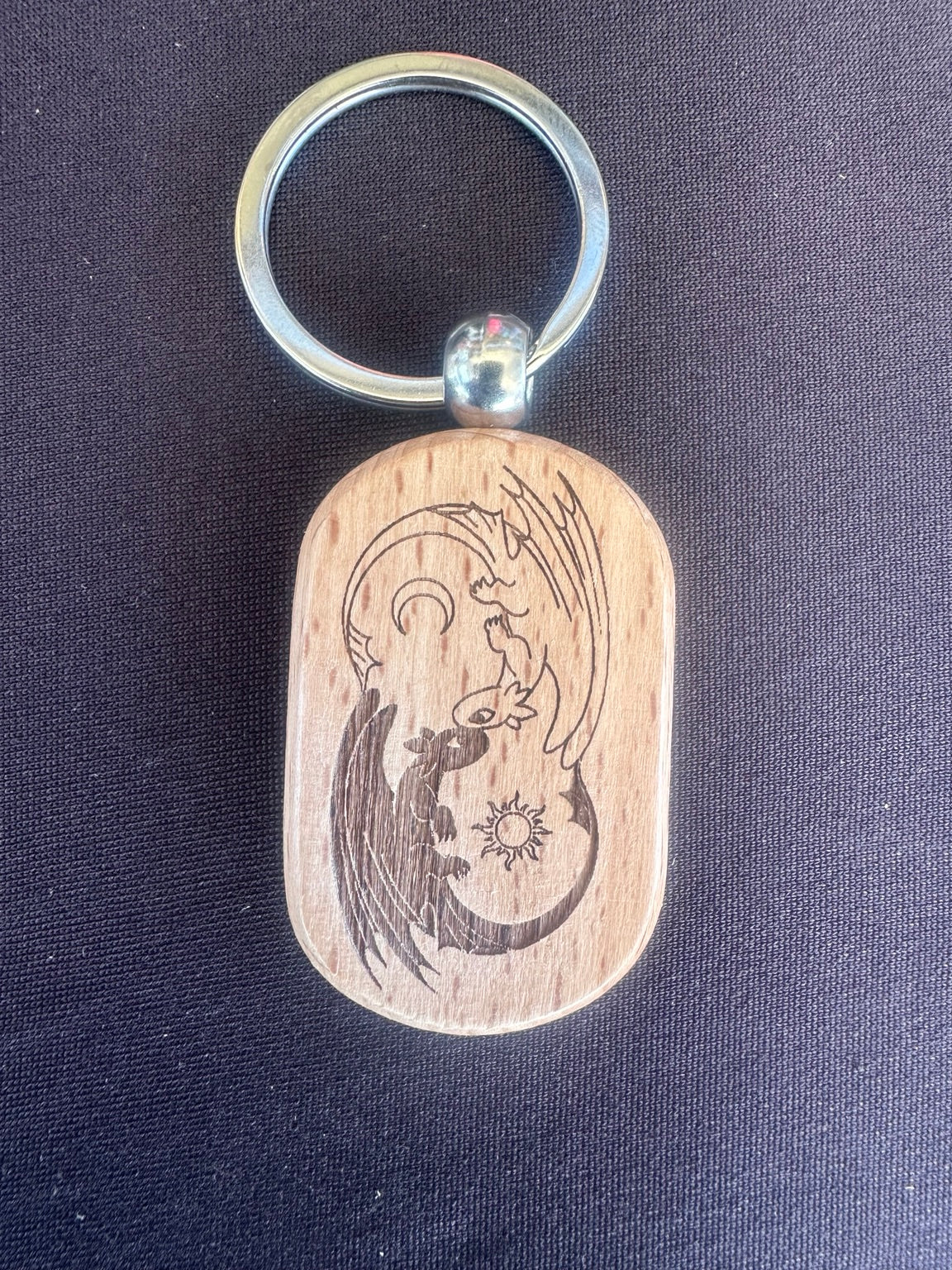Laser engraved wooden keychain with yin yang dragon design