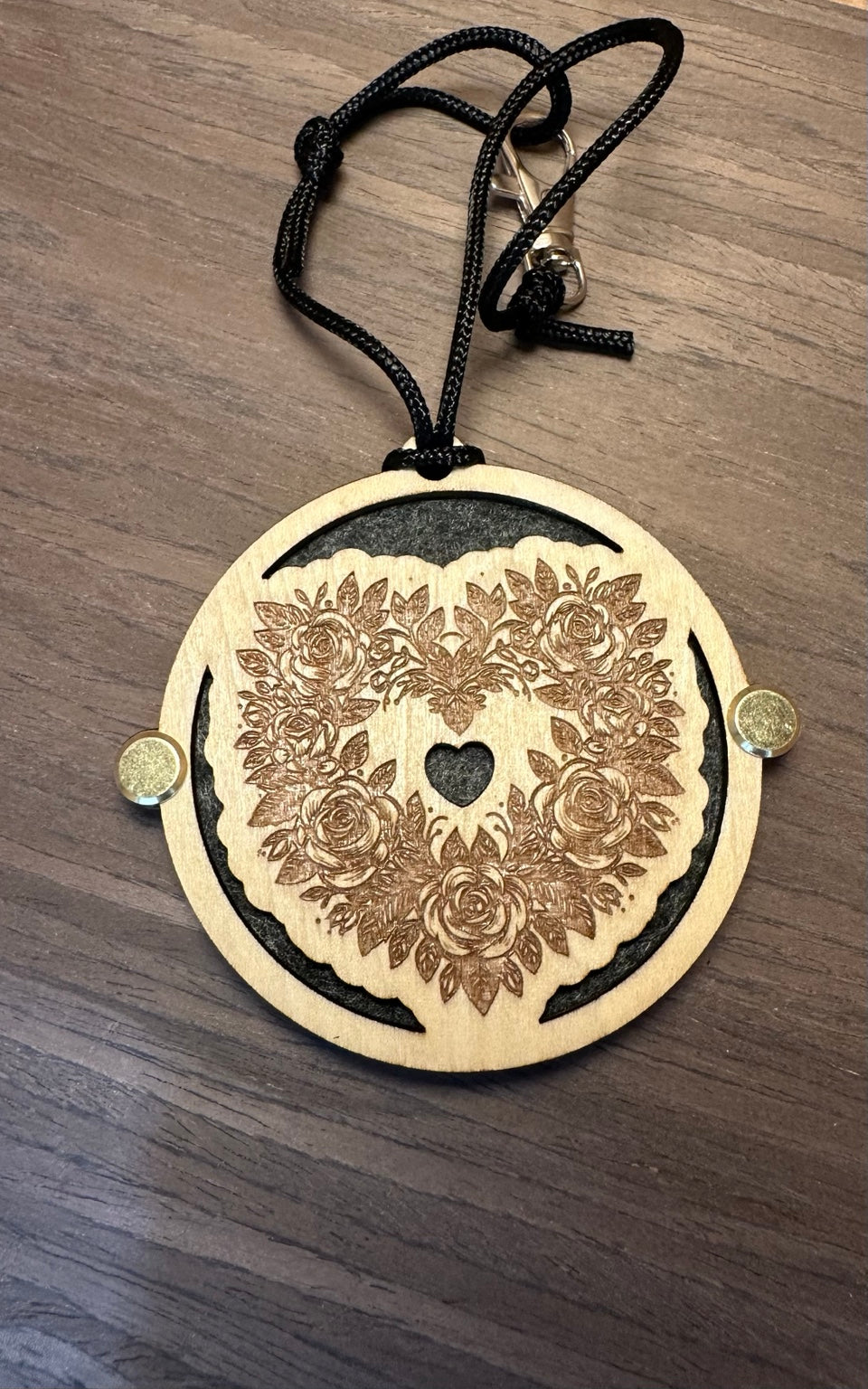 Laser cut and engraved basswood essential oil car freshener with floral skull design and black felt backing